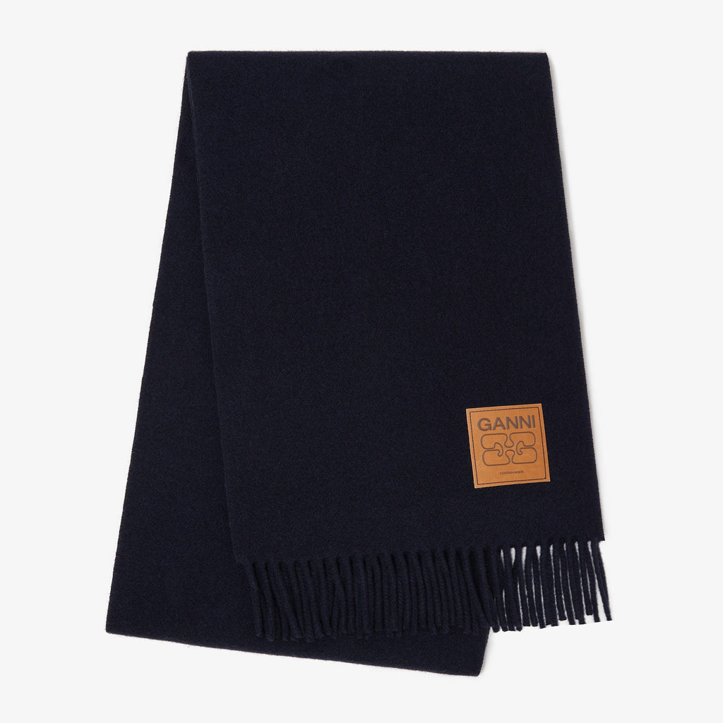 ganni wool scarf with fringing and a tan leather brand logo patch navy blue