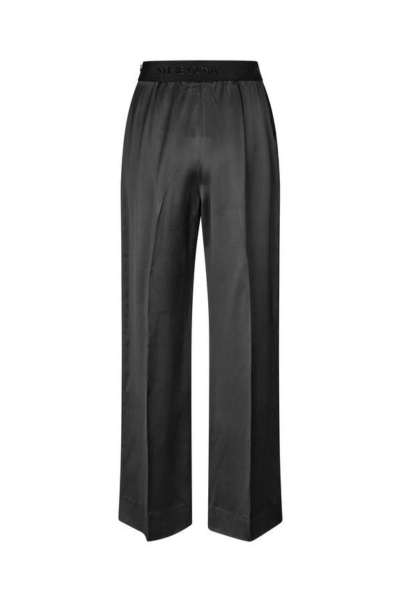 shiny jet black slouchy pull on Ciara trousers with elastic waist by stine goya