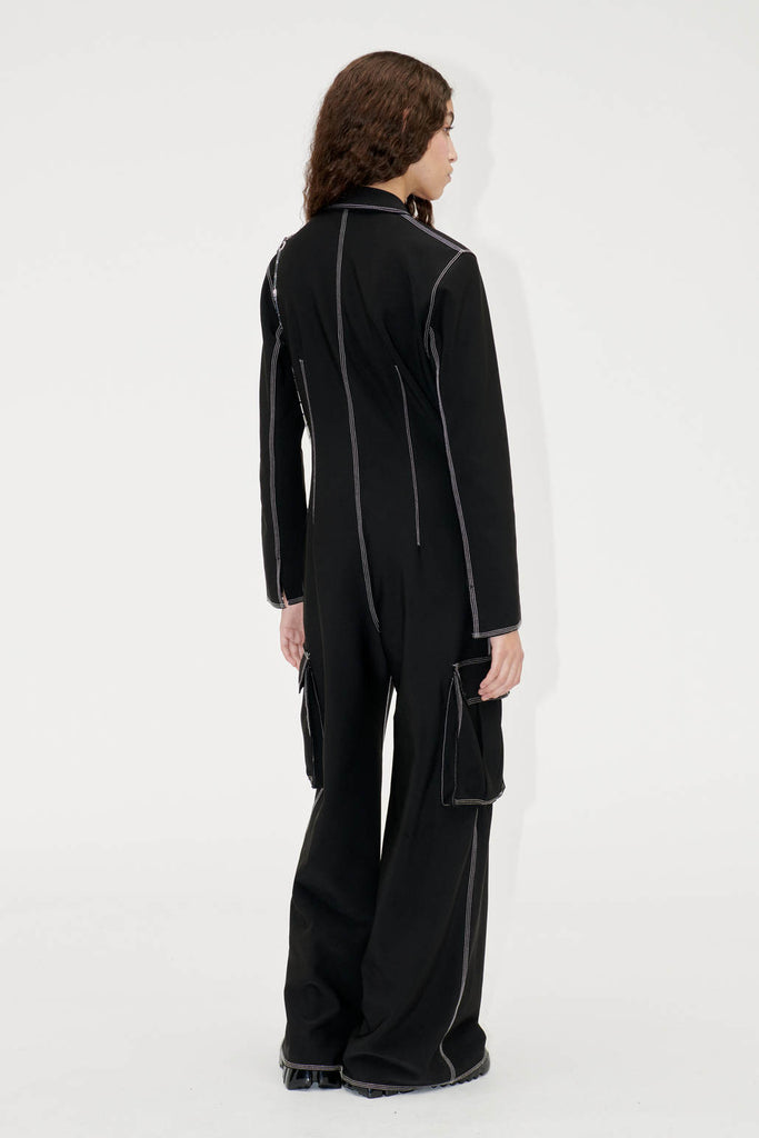 black loose slouchy cargo jumpsuit all in one by Stine Goya with white contrast stitching and side pockets
