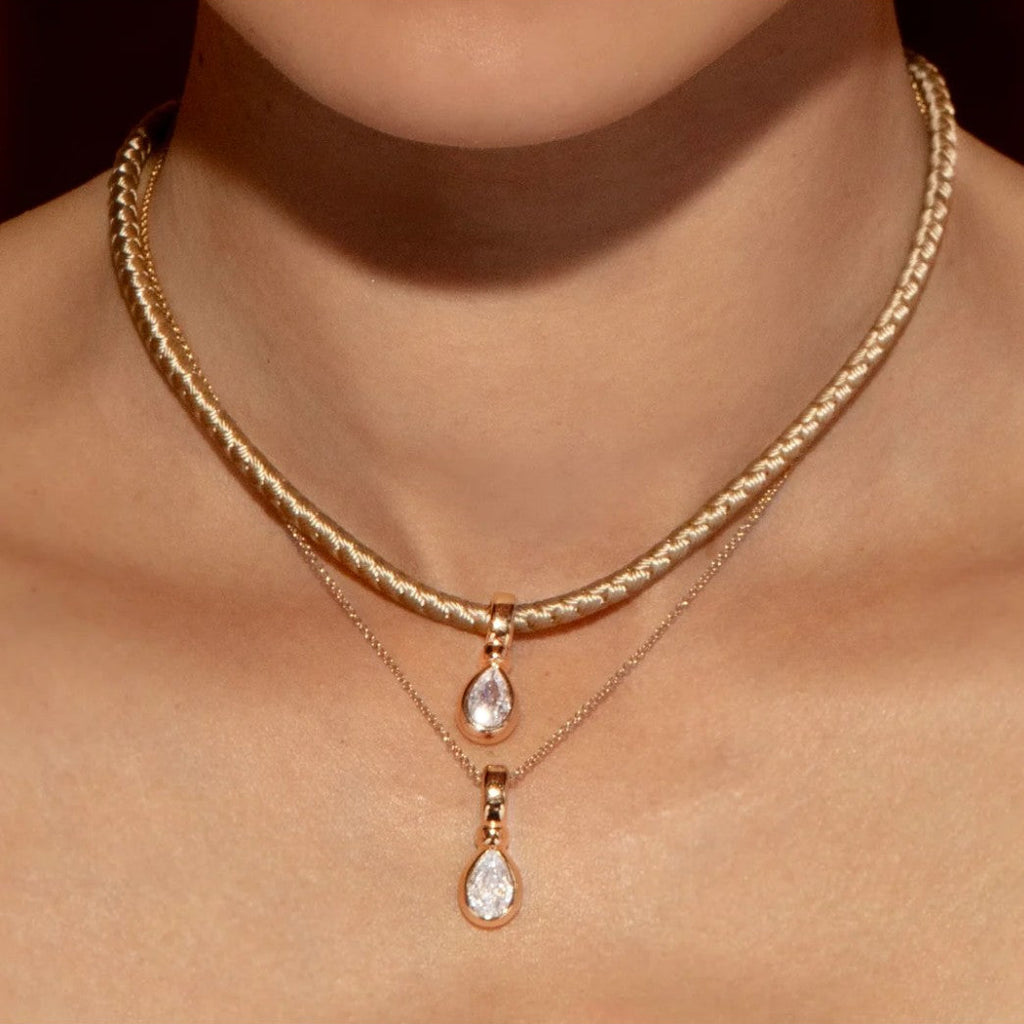 By Alona Auralis necklace from TAUPE braided cord 18K gold teardrop pendant with a sparkling cubic zirconia stone