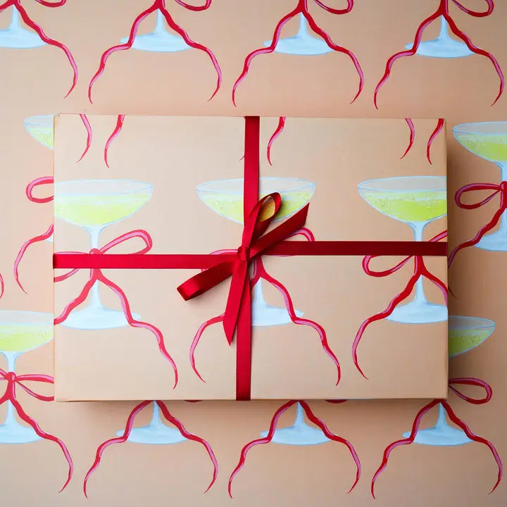 peach wrapping paper with a champagne saucer & ribbon print 