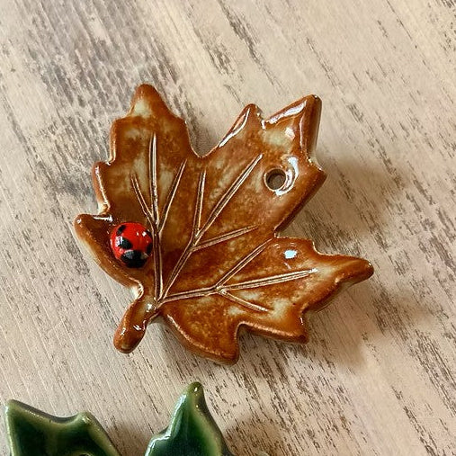 RUST BROWN glazed ceramic leaf Christmas decoration with a tiny ladybug detail by Chloe Charlett handmade in glasgow scotland