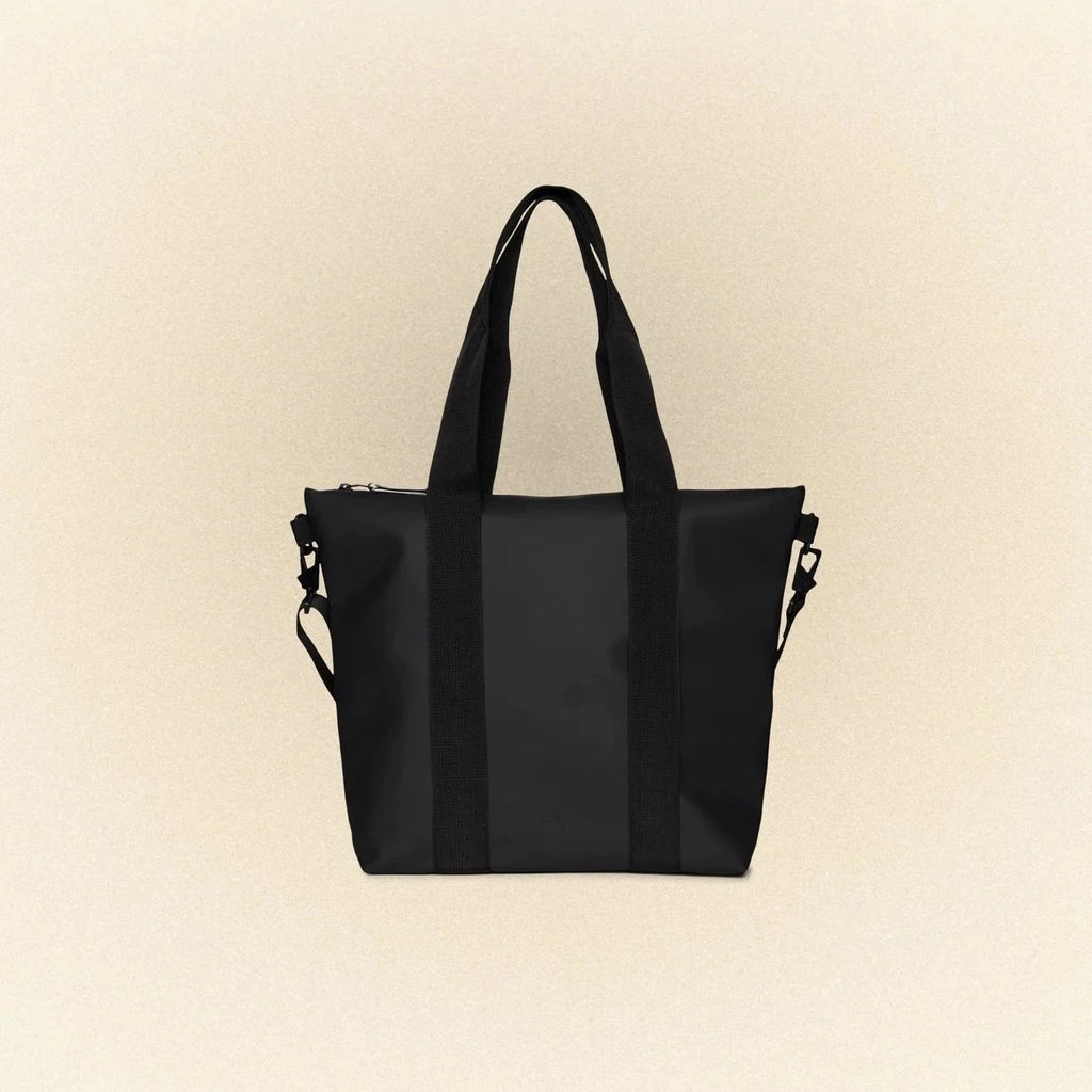 black waterproof tote bag mini by Rains with top handle and shoulder strap
