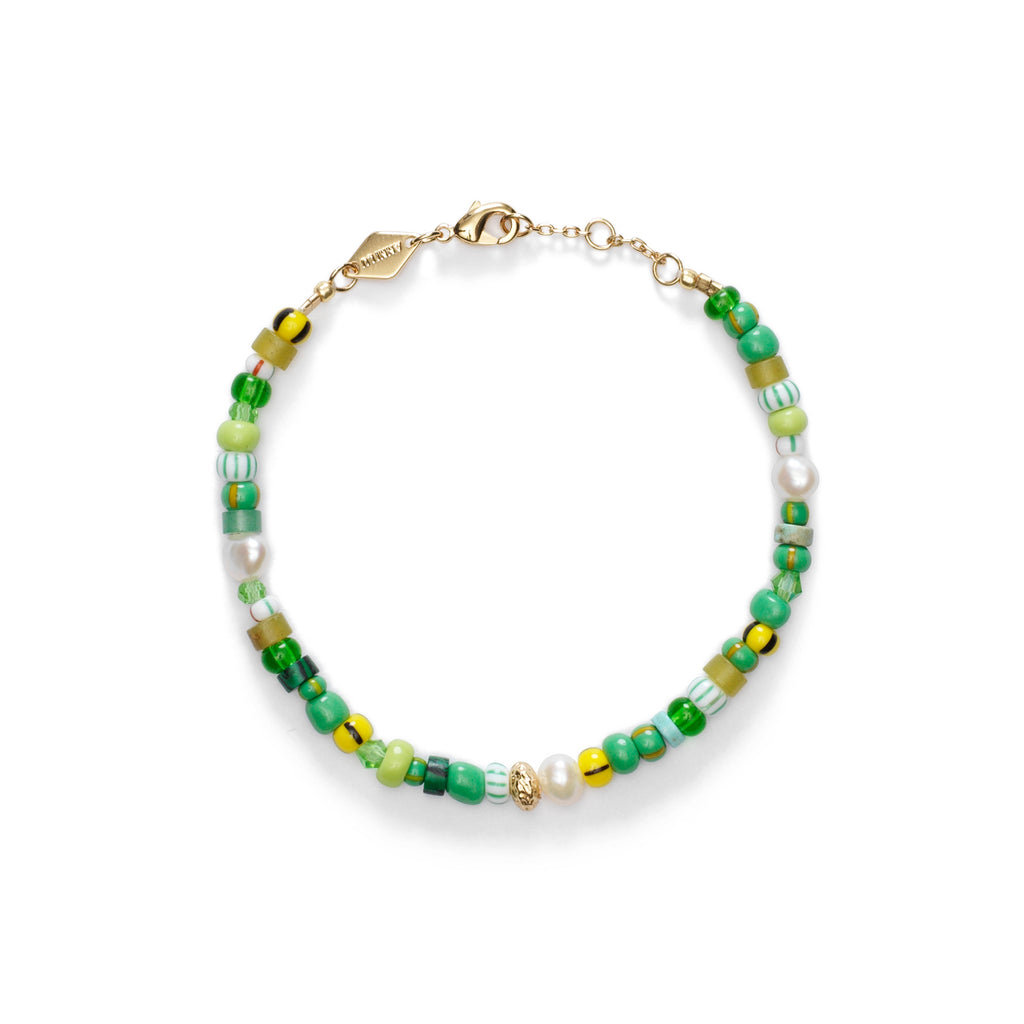 A bracelet by Anni Lu with green and yellow glass beads and pearls